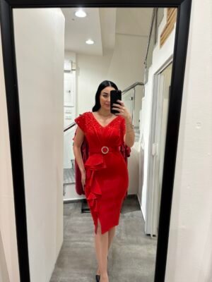 Short-medium length red dress studded with red rhinestones and pearls all over the chest